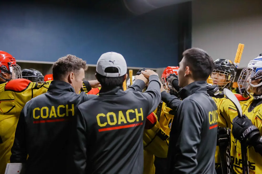 Coaches and players in a team huddle