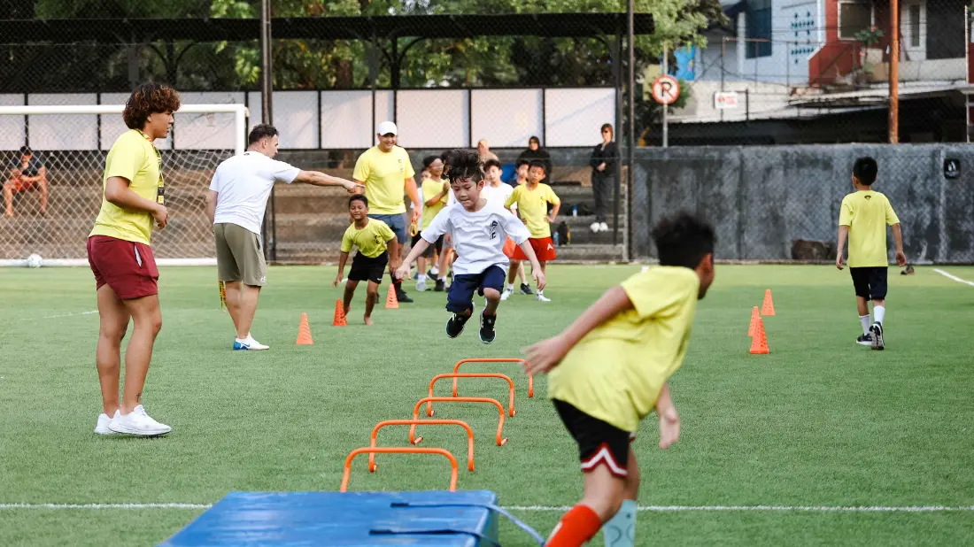 Young players running an off-ice agility course