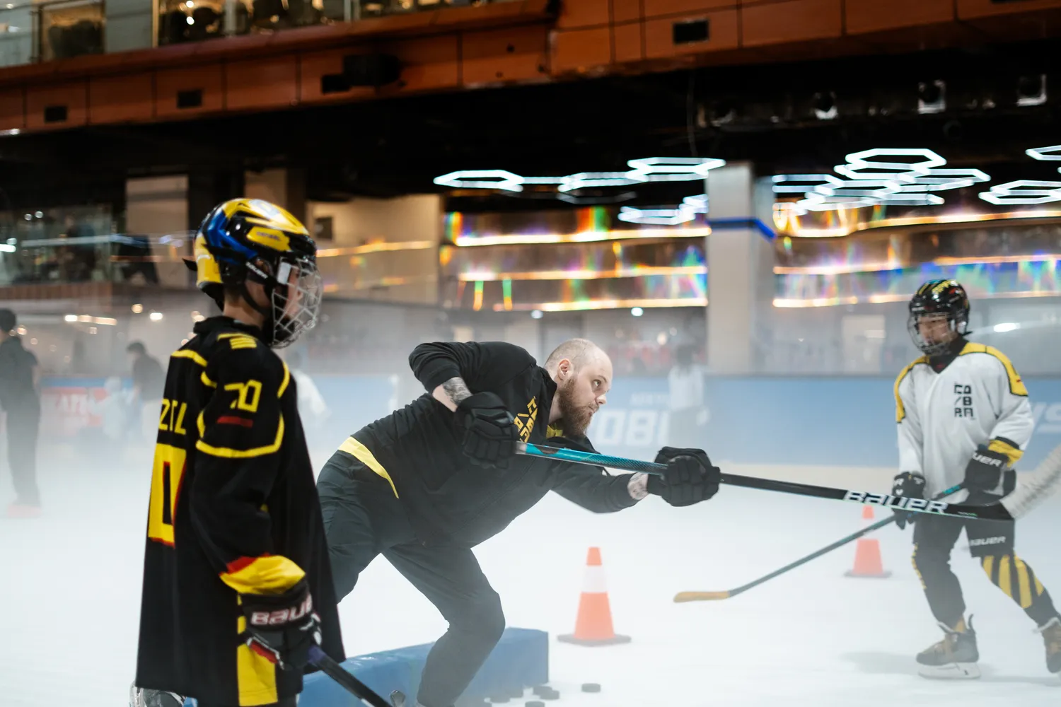 A coach running a stickhandling drill at BX Rink